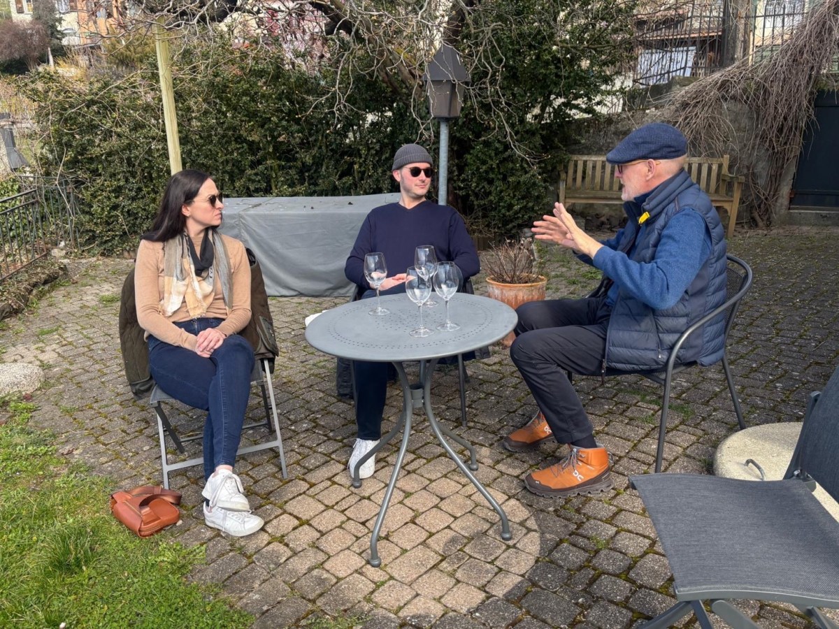 Lou and Bridget talking with Blaise during their Lavaux wine visit