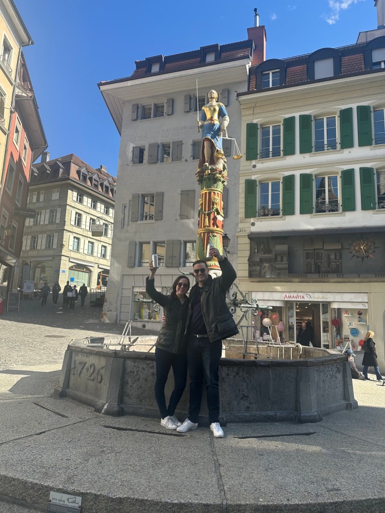 Lou and Bridget at a fountain while exploring Lausanne