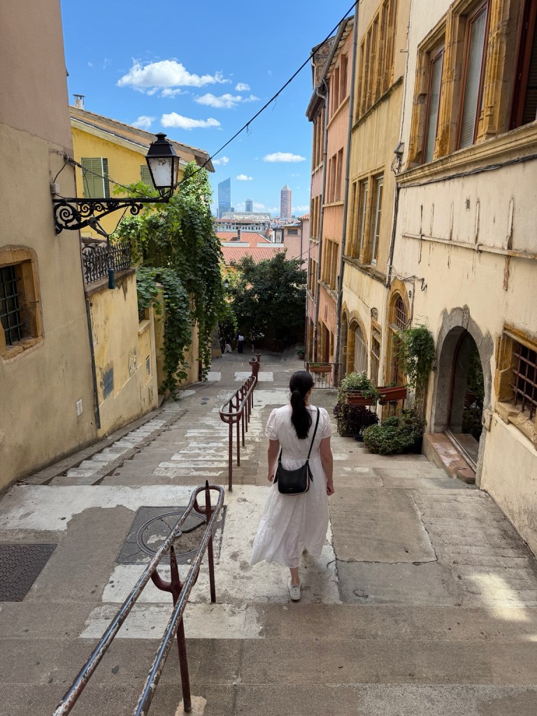 Bridget descending the long stone staircase in Lyon