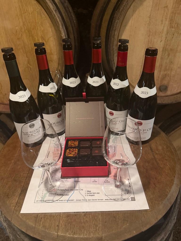 Domaine Lejeune wines and chocolates arranged on a barrel