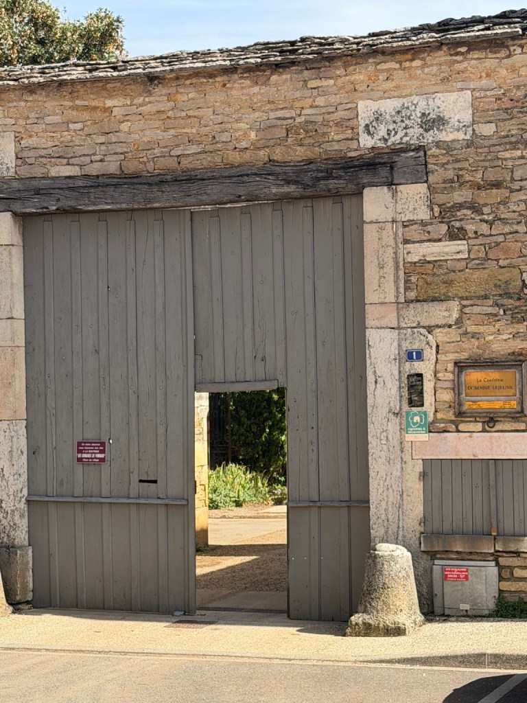 Stone gateway and wooden doors at Domaine Lejeune