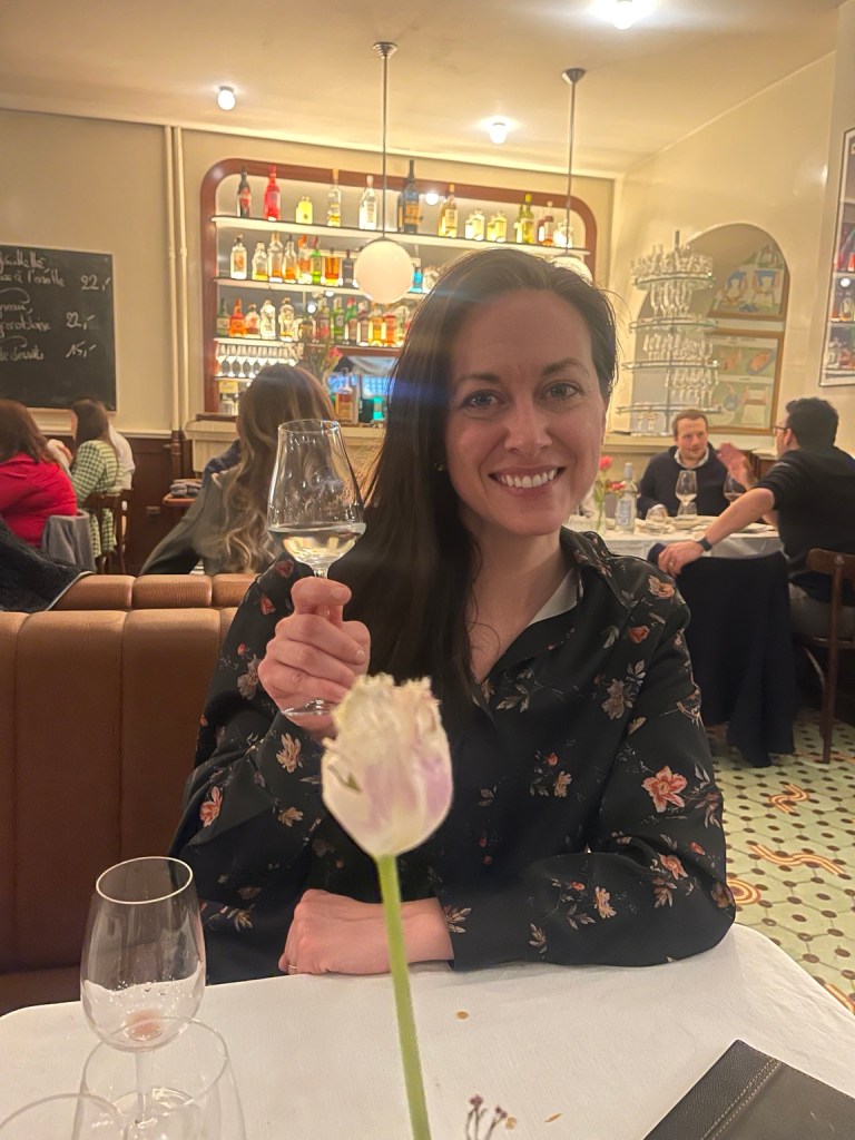 Bridget raising a glass at Le Bologne in Geneva